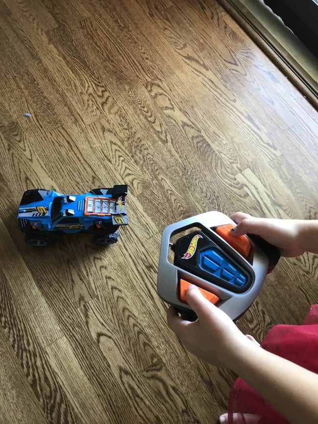 A child playing with a remote control car.