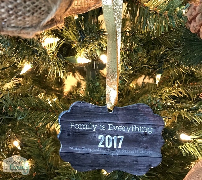 A wooden ornament hanging on a Christmas tree.