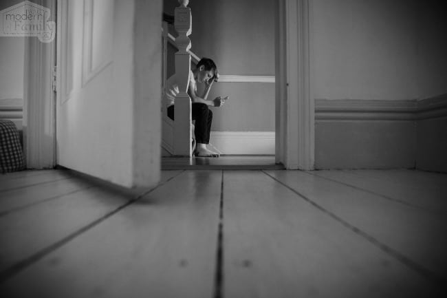 Picture of a boy sitting on the steps.