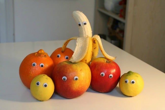 A bowl of oranges, apples and a banana on a table, with Joke for April Fool\'s Day.