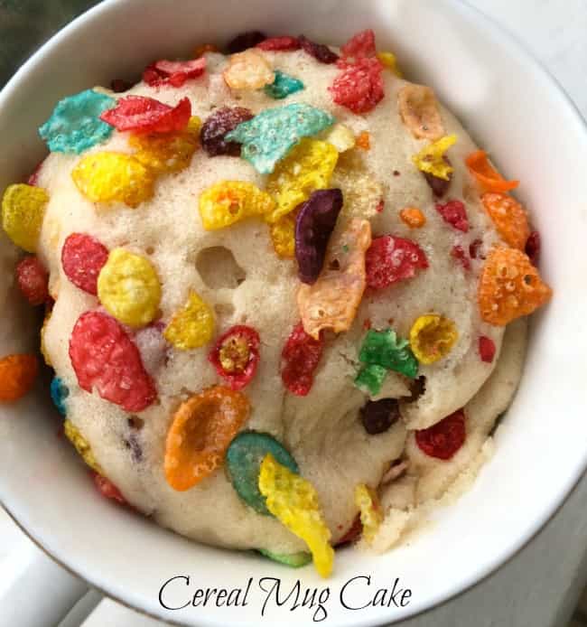 A white bowl containing a completed Fruity Pebbles microwave cake.