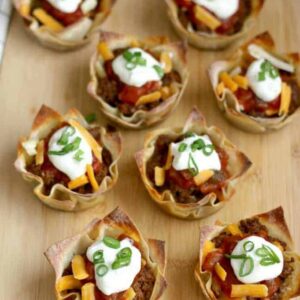A plate filled with Taco and Cheese cups for a football party.
