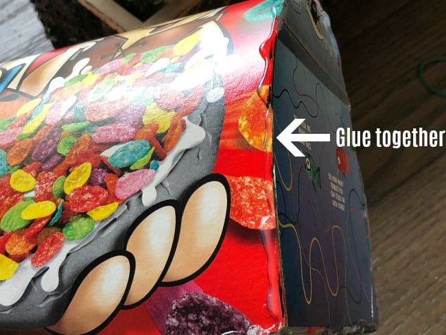 A close up of a mail box made from a box of Fruity Pebbles with directions on where to glue it.