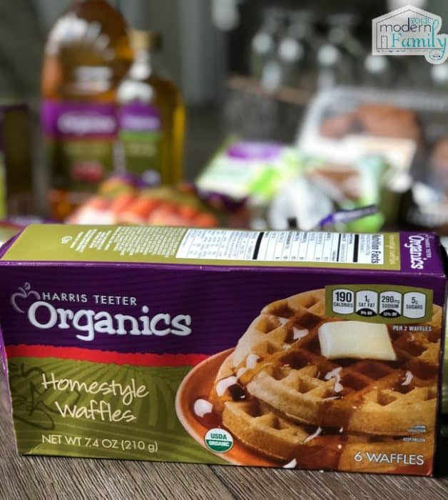 A close up of organic waffles with other organic food in the background.