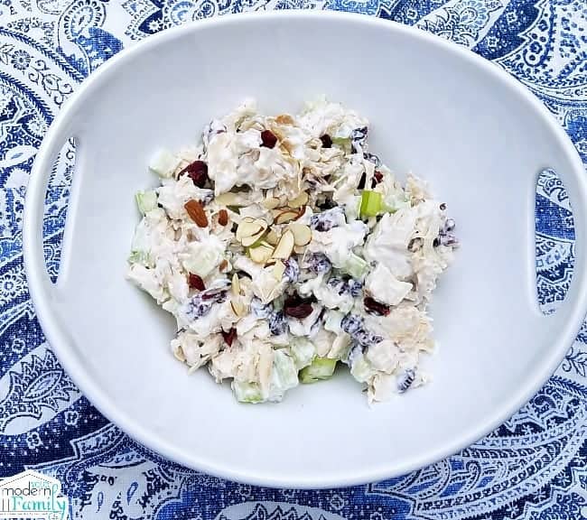 A bowl of chicken salad in a white bowl.