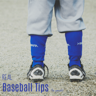 A back view of a little boys feet and legs wearing a baseball uniform.