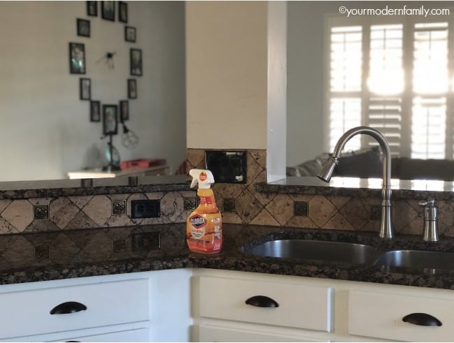 A kitchen with a spray bottle of Clorox sitting on the counter.