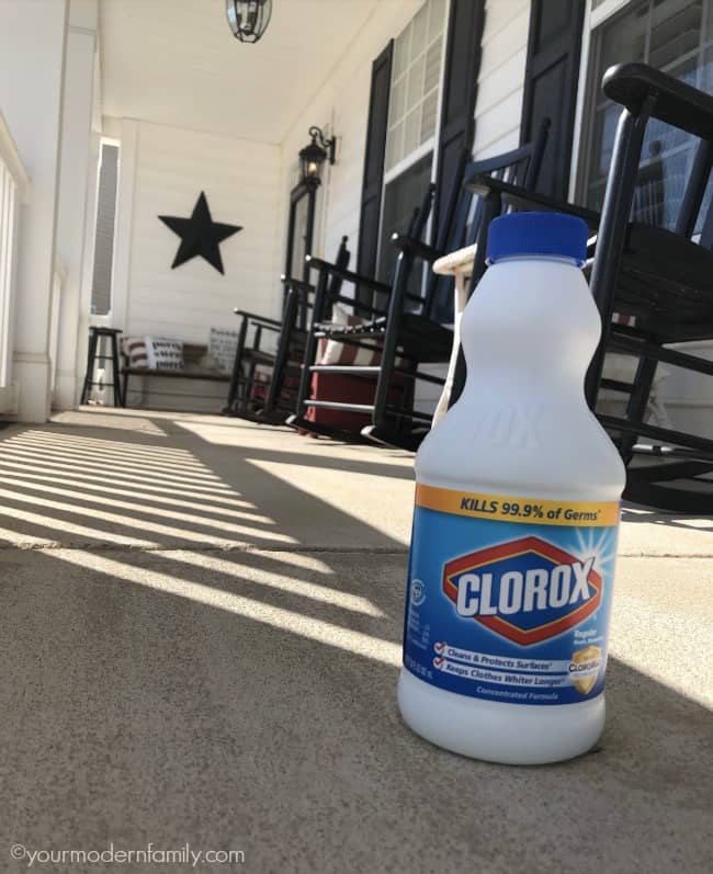 A close up of a bottle of Clorox sitting on the floor.