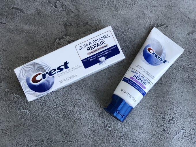 A tube of Crest and box sitting on a counter.