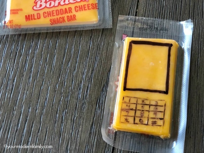 A cheesy snack bar in its wrapper decorated to look like a cell phone.