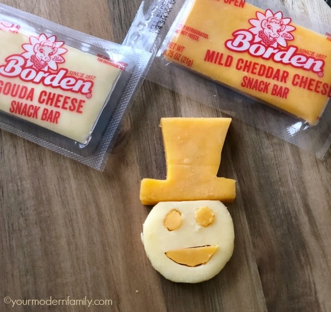 Borden cheesy snack bars cut to look like a snowman.