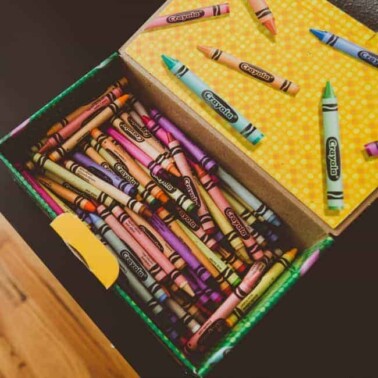 An open crayon box of crayons inside.