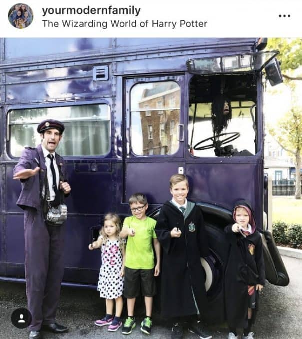 A group of kids dressed up as Harry Potter standing in front of a bus.