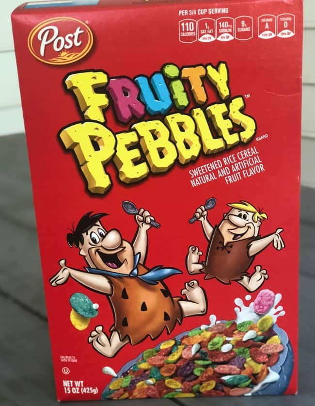 A close up of a box Fruity Pebbles sitting on a table.