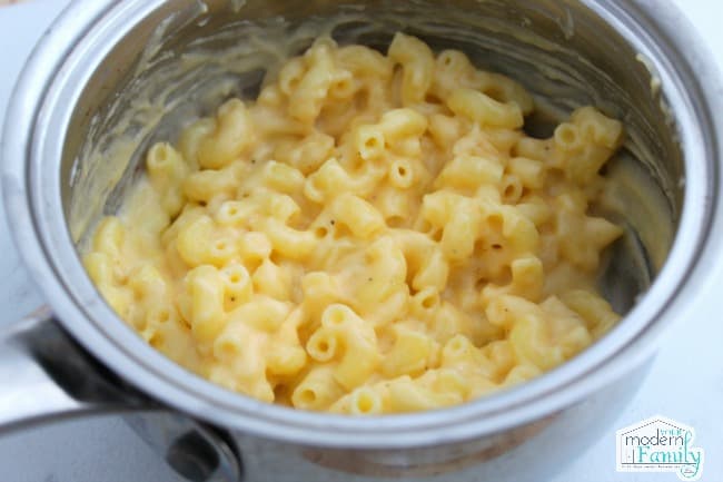 A metal pan with Macaroni and cheese.