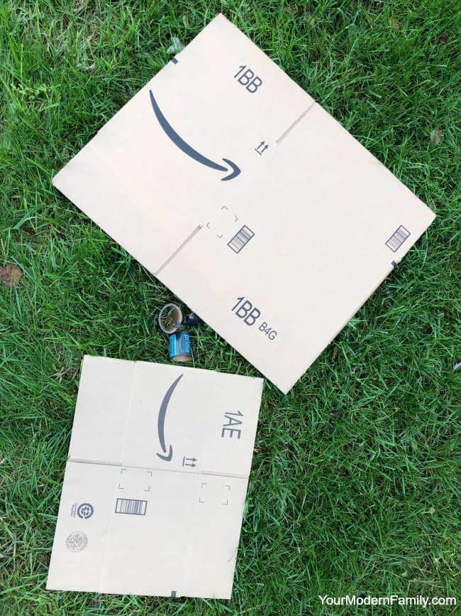 Two white boxes sitting in the grass.