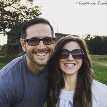 A couple of people posing for the camera with sunglasses on.