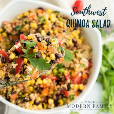 A bowl of food on a plate, with Quinoa and Salad