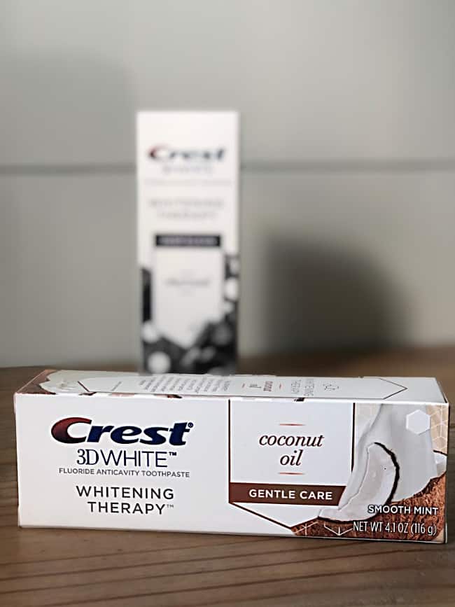 A close up of a box of Crest whitening tooth paste sitting on a counter.