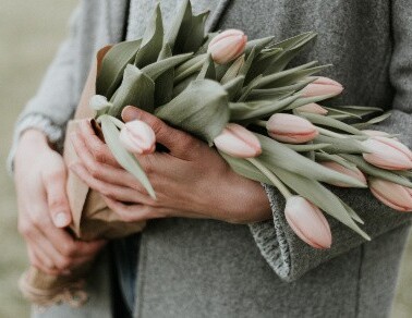 A woman holding a bouquet of flowers.