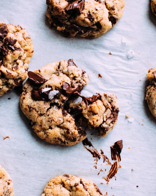 Chocolate chunk cookies on a white table cloth.