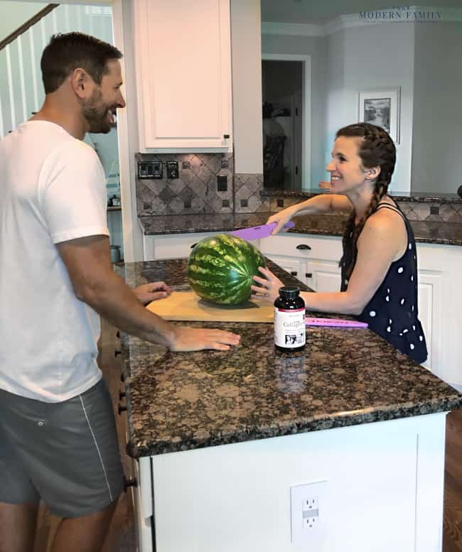Two people standing at a kitchen counter preparing food.