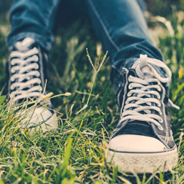 A close up of feet wearing blue shoes