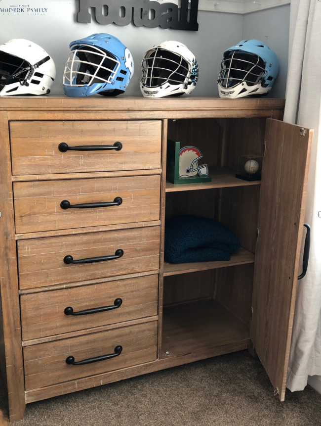 Chest of drawers with a closet with three shelves in it.