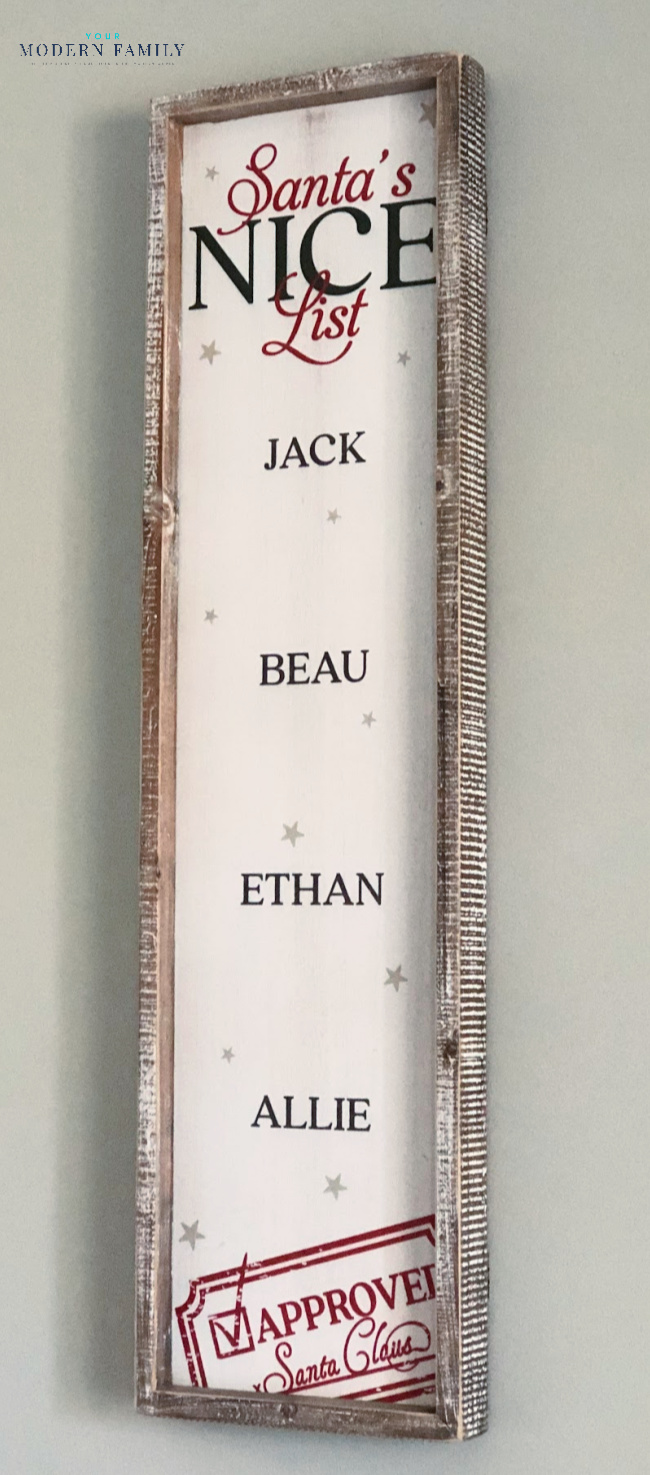A close up of children\'s names on a wooden Christmas decoration.