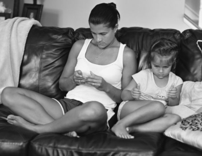 Mother & Child sitting pretending to be on phones