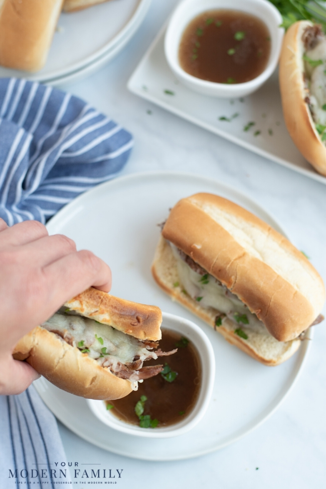 A sandwich on a plate, with French dip