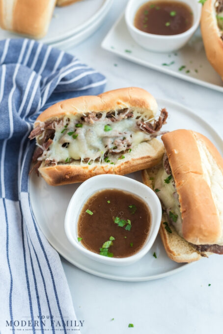 A tray of food on a plate, with Sandwich and French dip